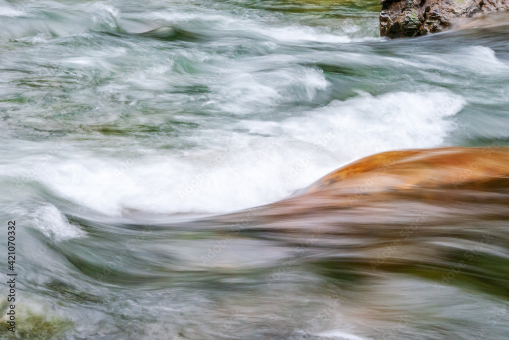 Majestic mountain river in slow motion with rocky background in Vancouver, Canada. Majestic mountain river in slow motion with rocky background in Vancouver, Canada.