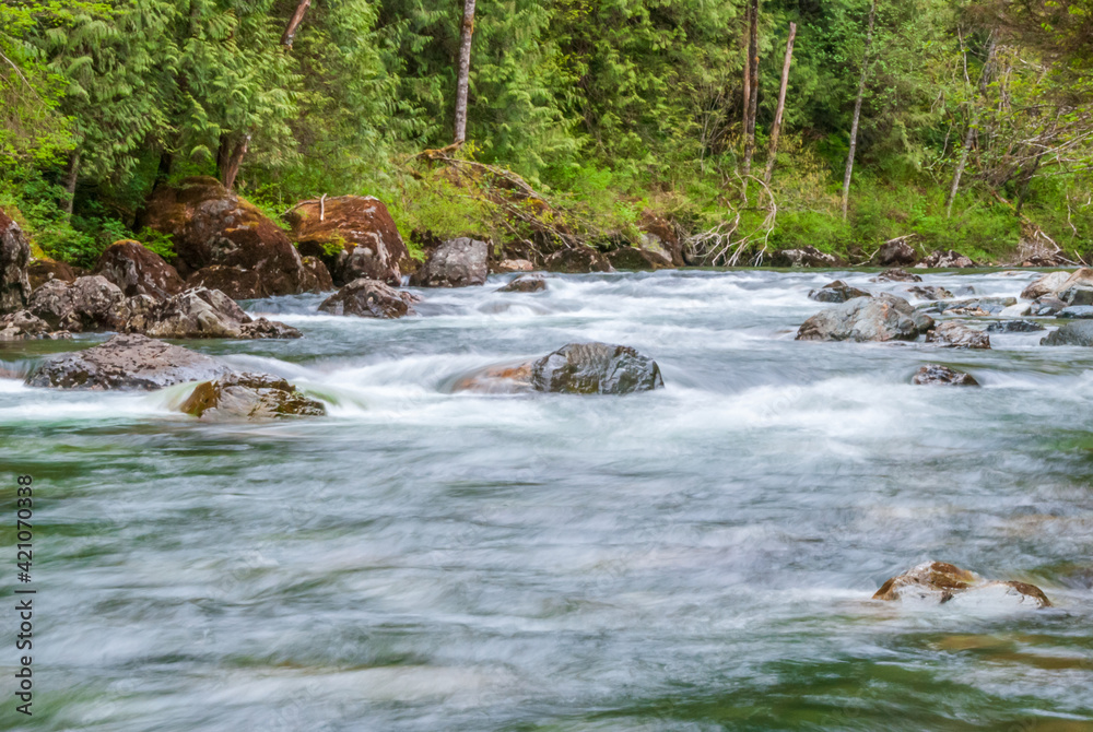 Majestic mountain river in slow motion with rocky background in Vancouver, Canada. Majestic mountain river in slow motion with rocky background in Vancouver, Canada.