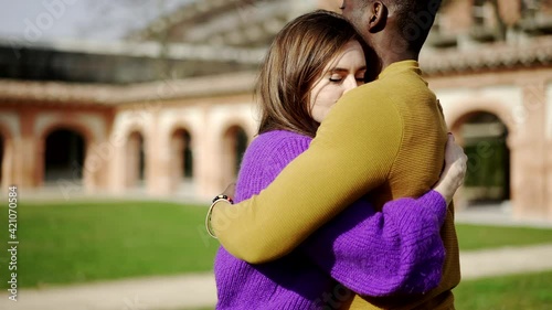 Young woman hugging male friend photo