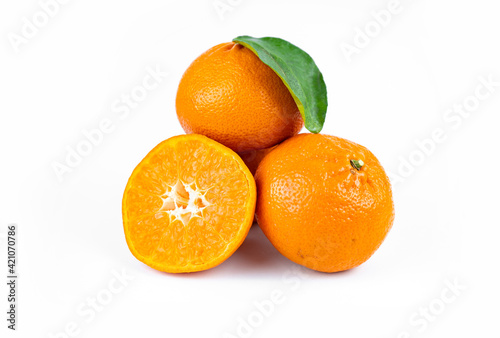 Ripe fresh juicy tangerines with leaves on white background