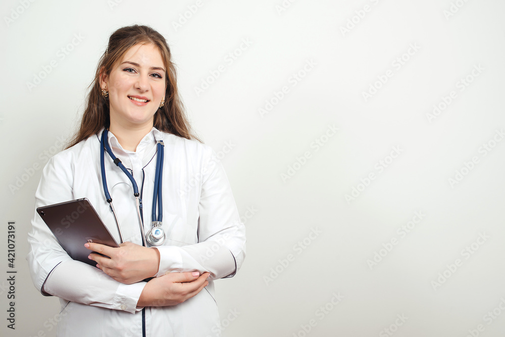 Doctor using tablet computer at work. Healthcare and medicine. Young doctor with stethoscope. Doctor using tablet computer at work. Healthcare and medicine. Young doctor with stethoscope.