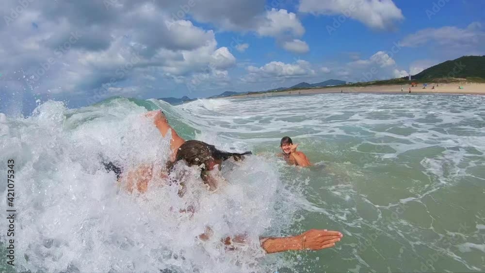 Bodysurfing. Young man rides the wave using only his body Bodysurfing. Young man rides the wave using only his body