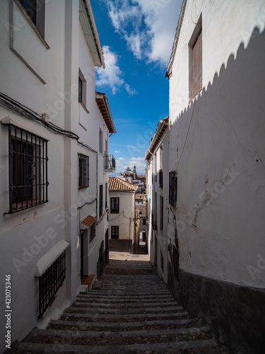 narrow street with stairs in the Albaicin in old city of Granada, Spain