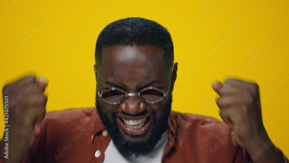 Closeup excited african american guy showing yes gesture on yellow background. Closeup excited african american guy showing yes gesture on yellow background.