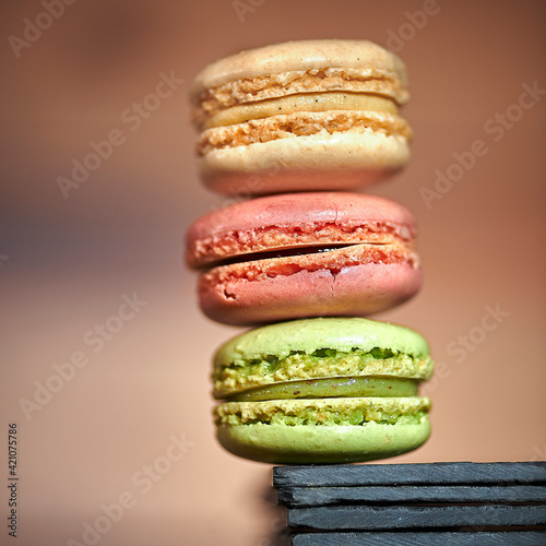 Sweet homemade pistachio flavored french macarons on the background of kitchen