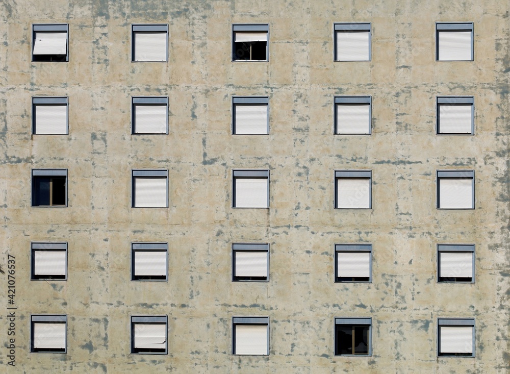 Fototapeta premium Peeling facade of an old abandoned apartment building. Background and texture.