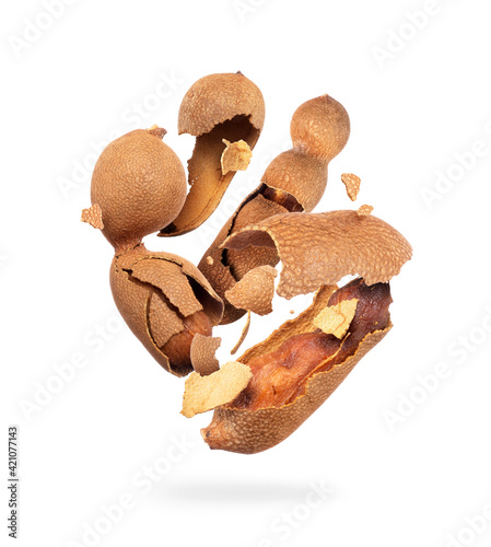 Crushed tamarind in the air close up on a white background