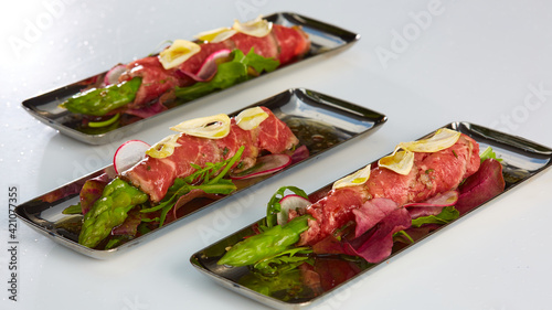 The asparagus covered in roasted beef. Mediterranean cuisine. Shallow dof