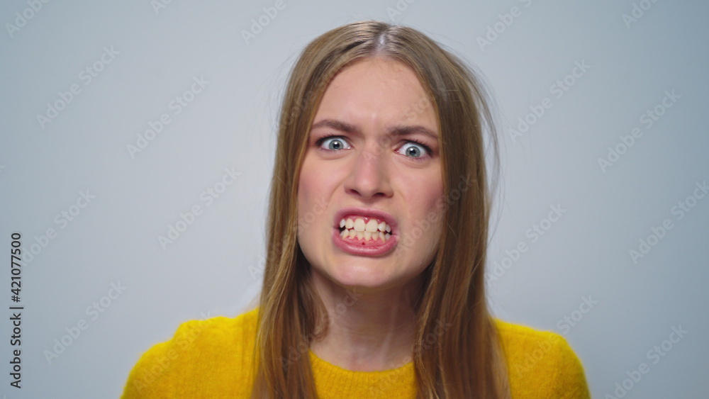 Portrait of angry woman screaming with aggressive emotion at camera in studio. Portrait of angry woman screaming with aggressive emotion at camera in studio.