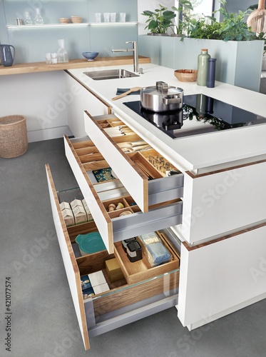 Modern kitchen, Open drawers, Set of cutlery trays in kitchen drawer. Solid oak wood cutlery drawer inserts.
