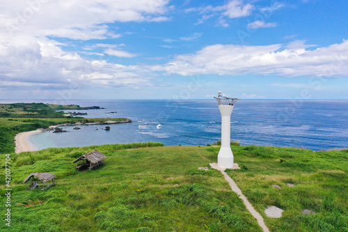 Lighthouse on a hill by the sea, top view. Basot Island, Caramoan, Camarines Sur, Philippines. photo