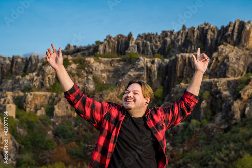 Portrait of a happy man sitting on the mountain, Cerro del Hierro. Spain.