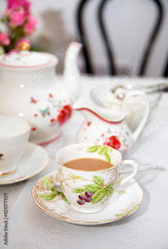 Table arrangement with floral china cups, saucers, jug and teapot