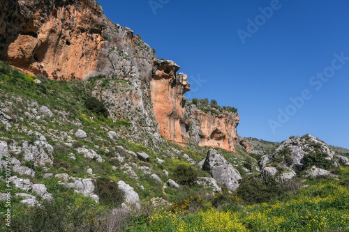 Colorful hard limestone cliffs and caves in Nahal [stream] Aviv deep canyon, east of Upper Galilee, Northern Israel, South of Lebanon border, Israel.