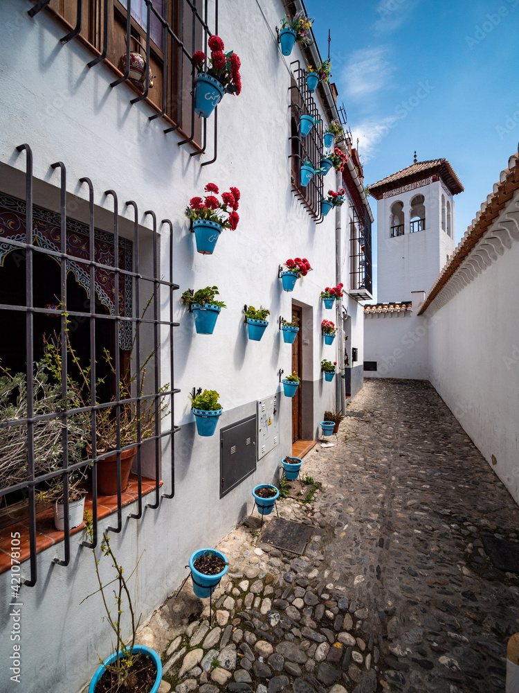 Fototapeta premium narrow street in the old town of Granada with Old Albaicin buildings, Spain