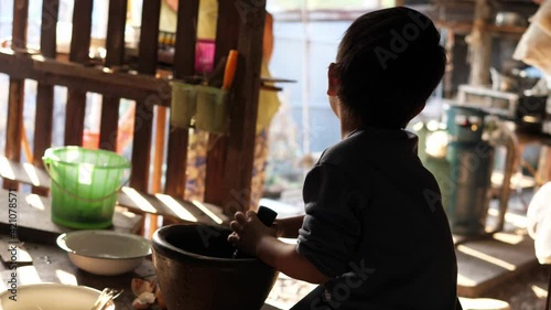 Wallpaper Mural 4K Asian cute child boy playing with mortar and pestle in rural kitchen. Kid helping cook food. Concept of family activity. Torontodigital.ca