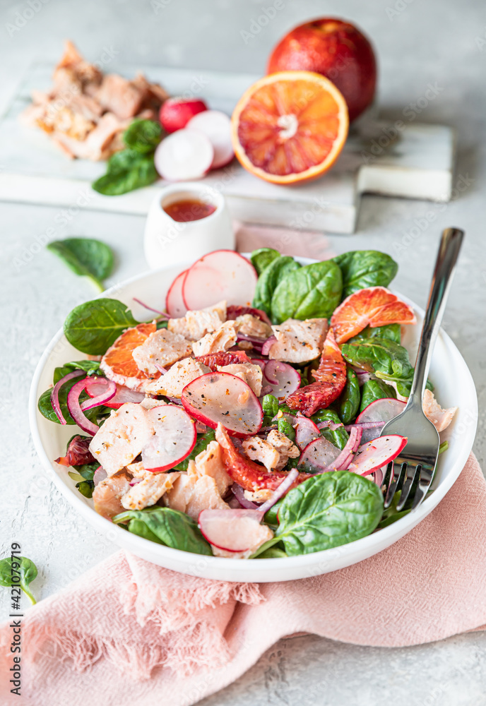Salmon salad with orange, spinach and radish with ingredient for making salad on wooden cutting board. Healthy food. Salmon salad with orange, spinach and radish with ingredient for making salad on wooden cutting board. Healthy food.