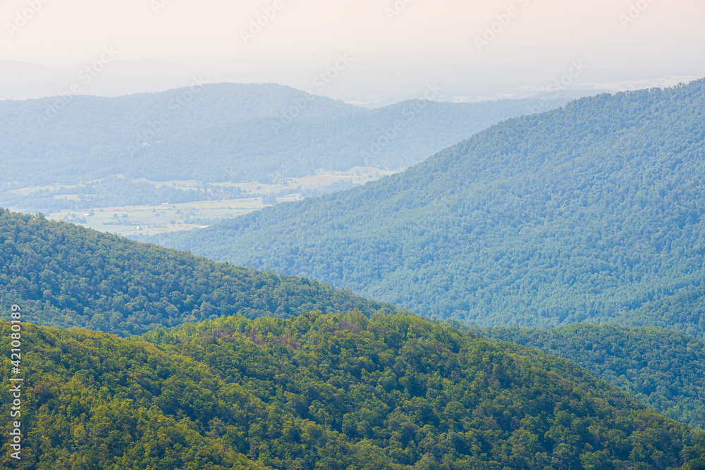 Aerial high angle view of Shenandoah Blue Ridge appalachian mountains, rolling hills from skyline drive overlook in Virginia with Stanley city rural village town