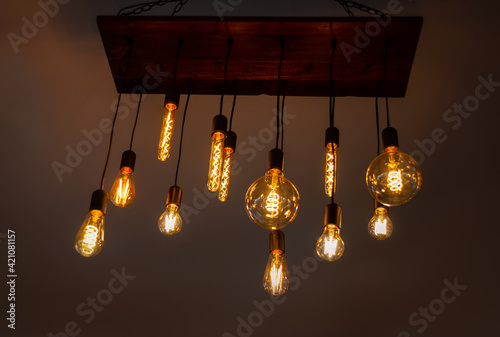 Old style bulb light hanging from ceiling, vintage indoor lamps photo