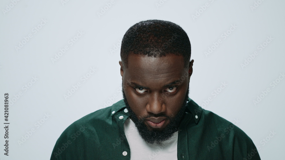 Obraz premium Portrait of smiling african handsome raising head in grey background.