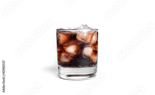 Cola with ice in a transparent glass isolated on a white background.