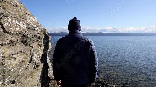 Visingso, Sweden A man walks through 12th century castle ruins at Nas on the island of Visingso on lake Vattern. photo