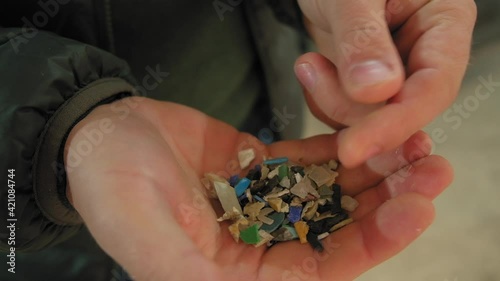 A mixture of plastic and sand to be recycled into something new. New life to old plastic. a worker in a factory recruits a special composition of recycled plastic to create a new product.