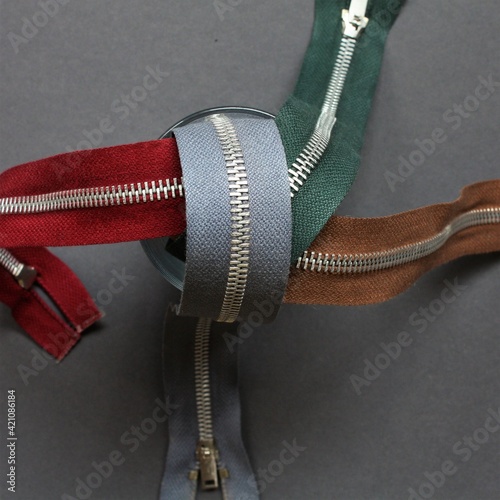 colored zippers on gray background
