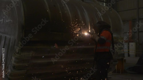 Boilermaker working on excavator bucket air gouging photo