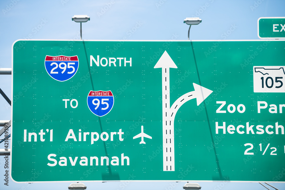 Jacksonville, Florida interstate highway 295 with traffic road sign to i-95 international airport of Savannah and Zoo parkway with cars driving in summer