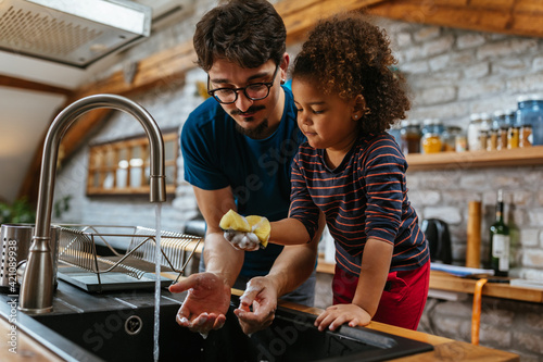 Father and daughter doing the dishes together