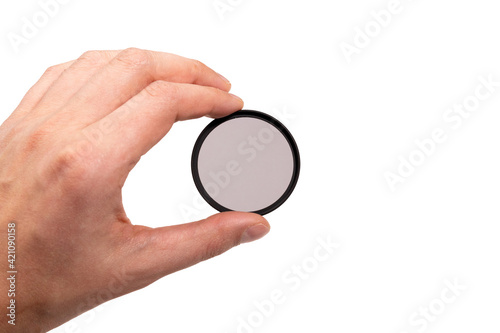 polarizing filter for the camera in hand. isolated on a white background