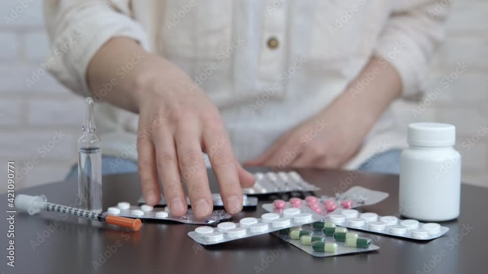 Pills and drugs on the table. Online doctor consultation. The female doctor speaks to the camera. Pills and drugs on the table. Online doctor consultation. The female doctor speaks to the camera.