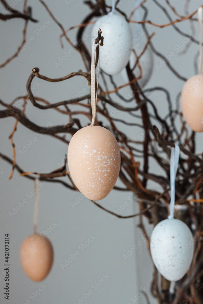 Colored easter eggs on tree branches in vase
