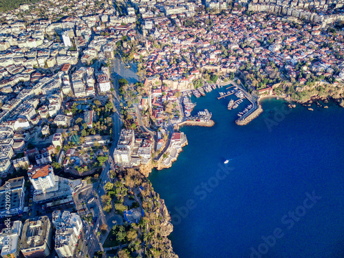 Aerial photograph of Antalya bay in Antalya city from high point of drone fly on sunny day in in Turkey. Amazing aerial cityscape view from birds fly altitude on beautiful town and sea full of yahts