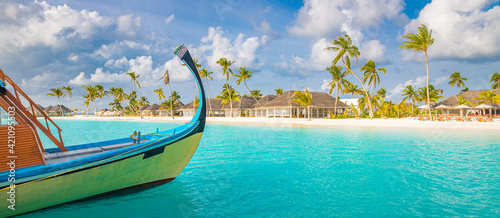 Inspirational Maldives beach design. Maldives traditional boat Dhoni and perfect blue sea with lagoon. Luxury tropical resort hotel paradise view. Idyllic coast, shore with white sand, palm trees