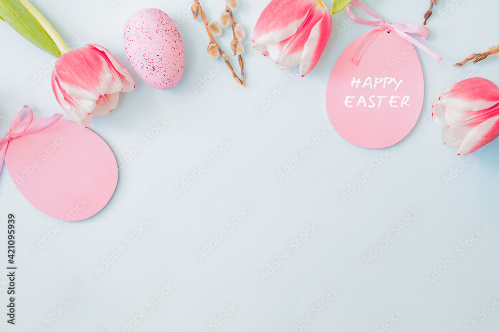 Flat lay easter composition with pink tulips and eggs on color background