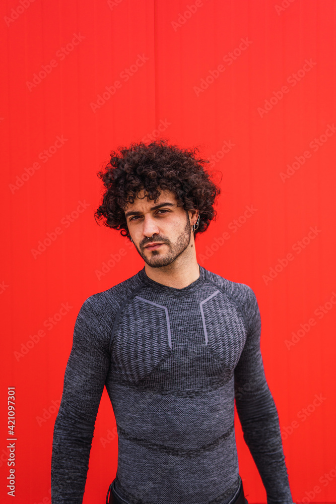 Portrait of a young man posing in a red wall Portrait of a young man posing in a red wall