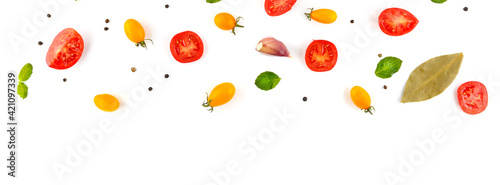 cherry tomato, garlic, pepper and bay leaf. Vegetables isolated on white background. Wide photo. Free space for text.