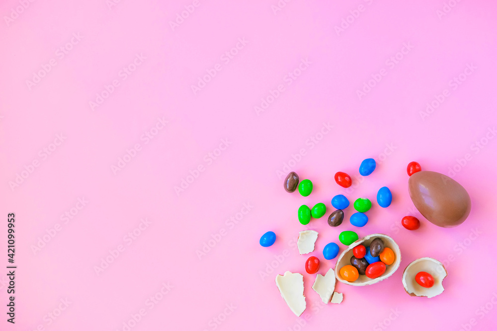Chocolate colorful Easter eggs on pink background Chocolate colorful Easter eggs on pink background