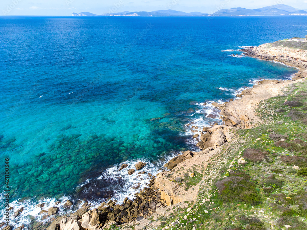 Blue sea in Alghero shore with Capo Caccia on the background Blue sea in Alghero shore with Capo Caccia on the background