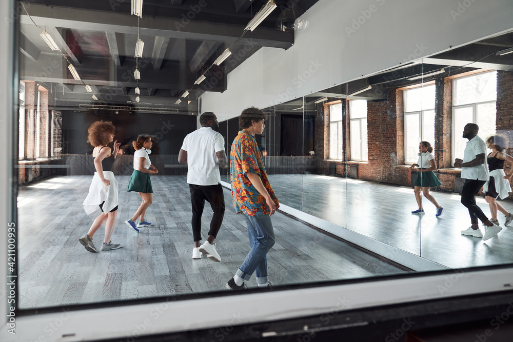 Fototapeta premium Happy young people during dancing class indoors