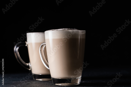 Two cups of chai latte, hot tea drink with foamed milk