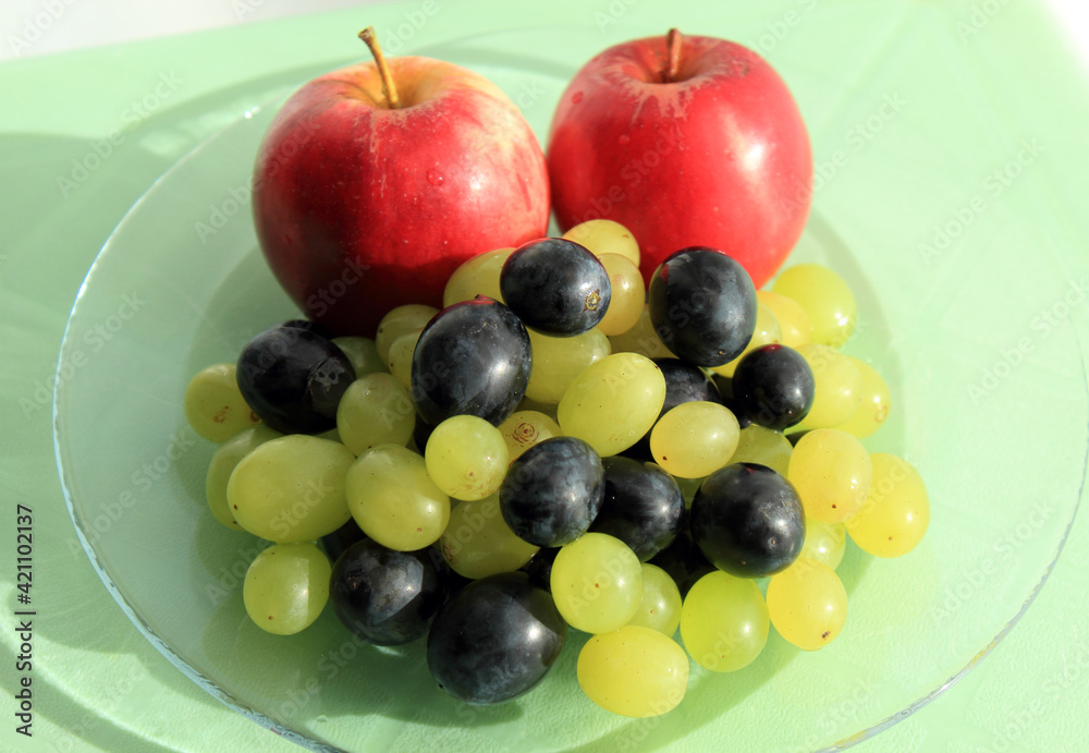 Fresh fruit on glass platter on the table Fresh fruit on glass platter on the table