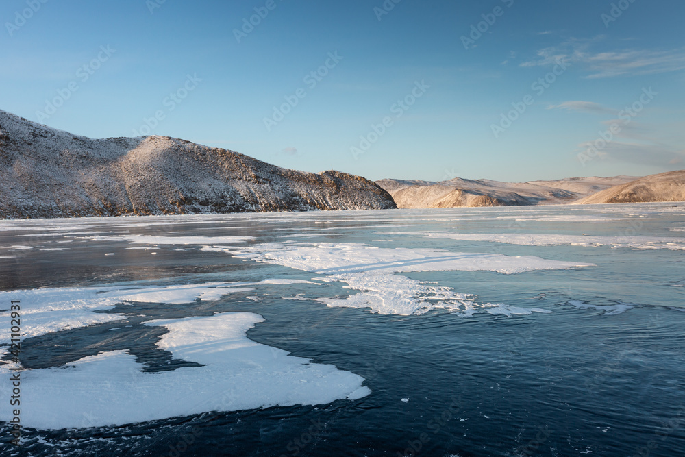Frozen Lake Baikal. Blue ice, winter landscape.