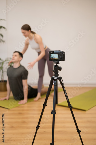 Man and woman teaching online yoga classes