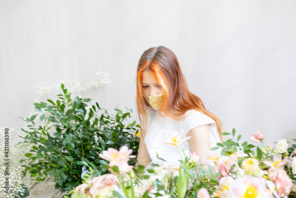 blurred in motion portrait of red haired teen girl among the flowers blurred in motion portrait of red haired teen girl among the flowers