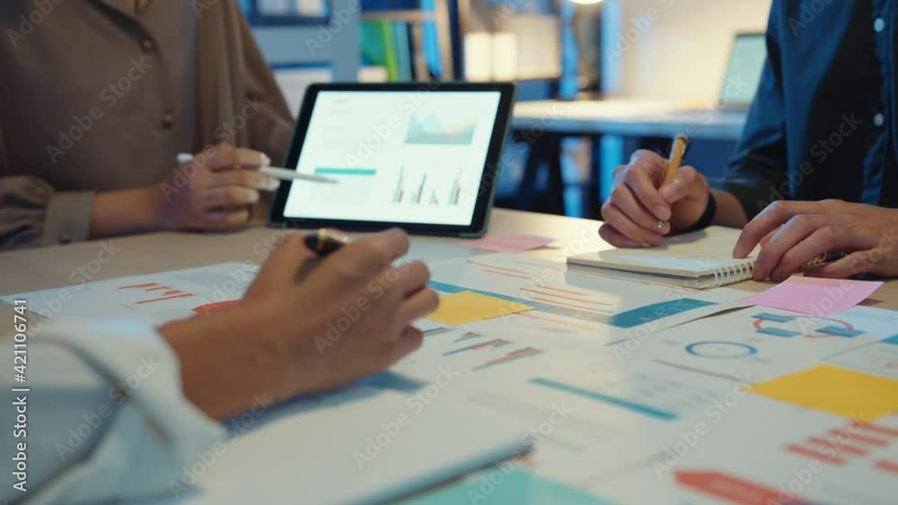Close-up asia business people meeting plan analysis statistics brainstorm and header of team hold tablet pointing graph chart and employee take note. Finance strategy statistics success concept.