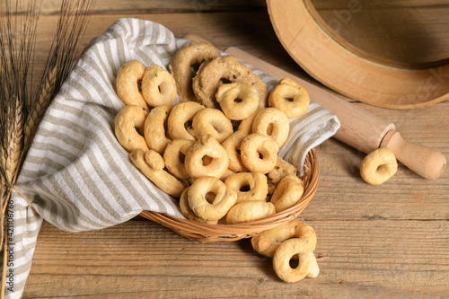 Taralli is a traditional Italian snack food typical of Puglia regional cuisine in wooden bowl. Ingredients: wine, olive oil, salt, flour of wheat photo
