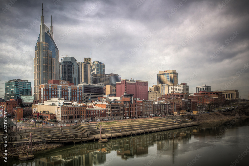 The skyline of downtown Nashville on the banks of the Cumberland River. 